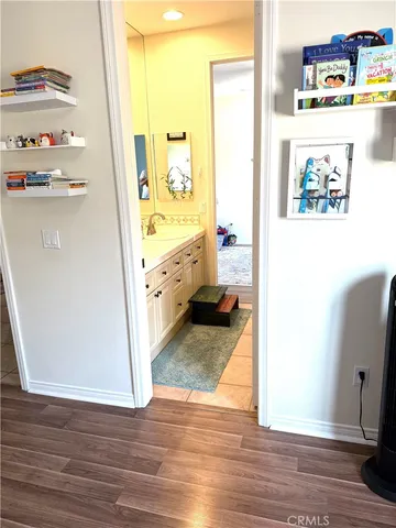 a bedroom with furniture and a wooden floor