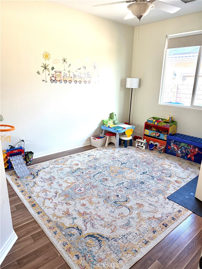 244 Via Padua Rancho Mirage, CA 92270 - Photo 33 of 35 a bedroom with furniture and a wooden floor
