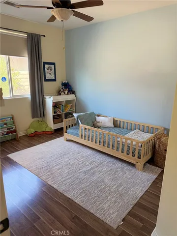 a view of a bedroom with wooden floor and bedroom