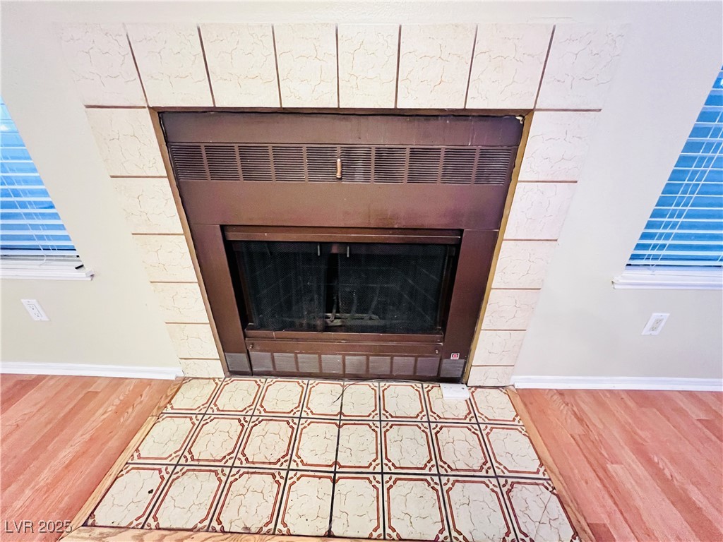 5048 Spencer Street, Unit C Las Vegas, NV 89119 - Photo 4 of 20 Detailed view of a tile fireplace and wood finished floors