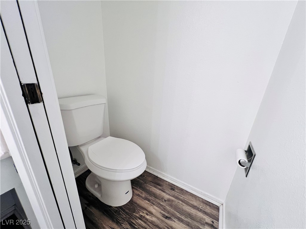 5048 Spencer Street, Unit C Las Vegas, NV 89119 - Photo 8 of 20 Bathroom featuring dark wood-style floors and baseboards
