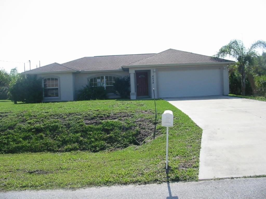4034 Santa Ana Road North Port, FL 34286 - Photo 1 of 1 a backyard of a house with large trees and plants