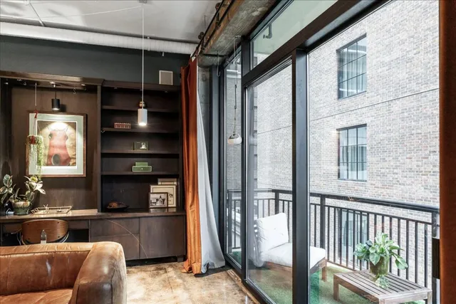 a living room with furniture a rug and a window