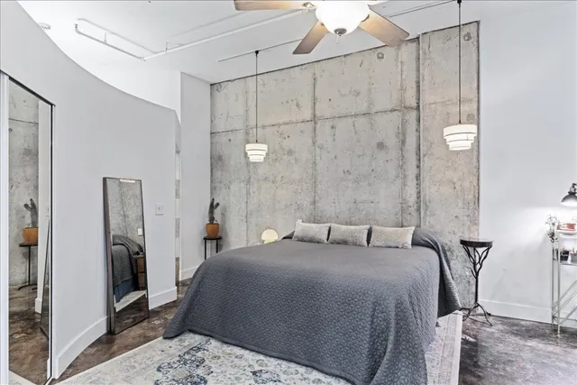 a bedroom with a bed and a large mirror