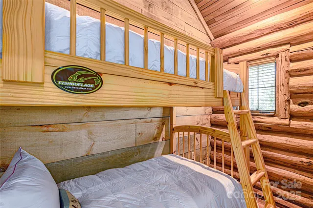 a view of a house with a wooden fence next to a road