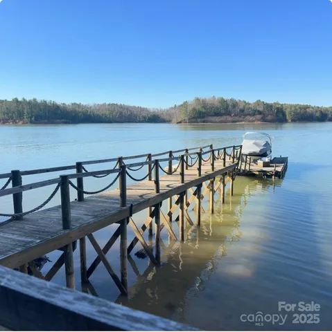 a view of a lake with a table and chairs