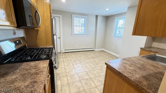 a kitchen with a sink a stove and a refrigerator