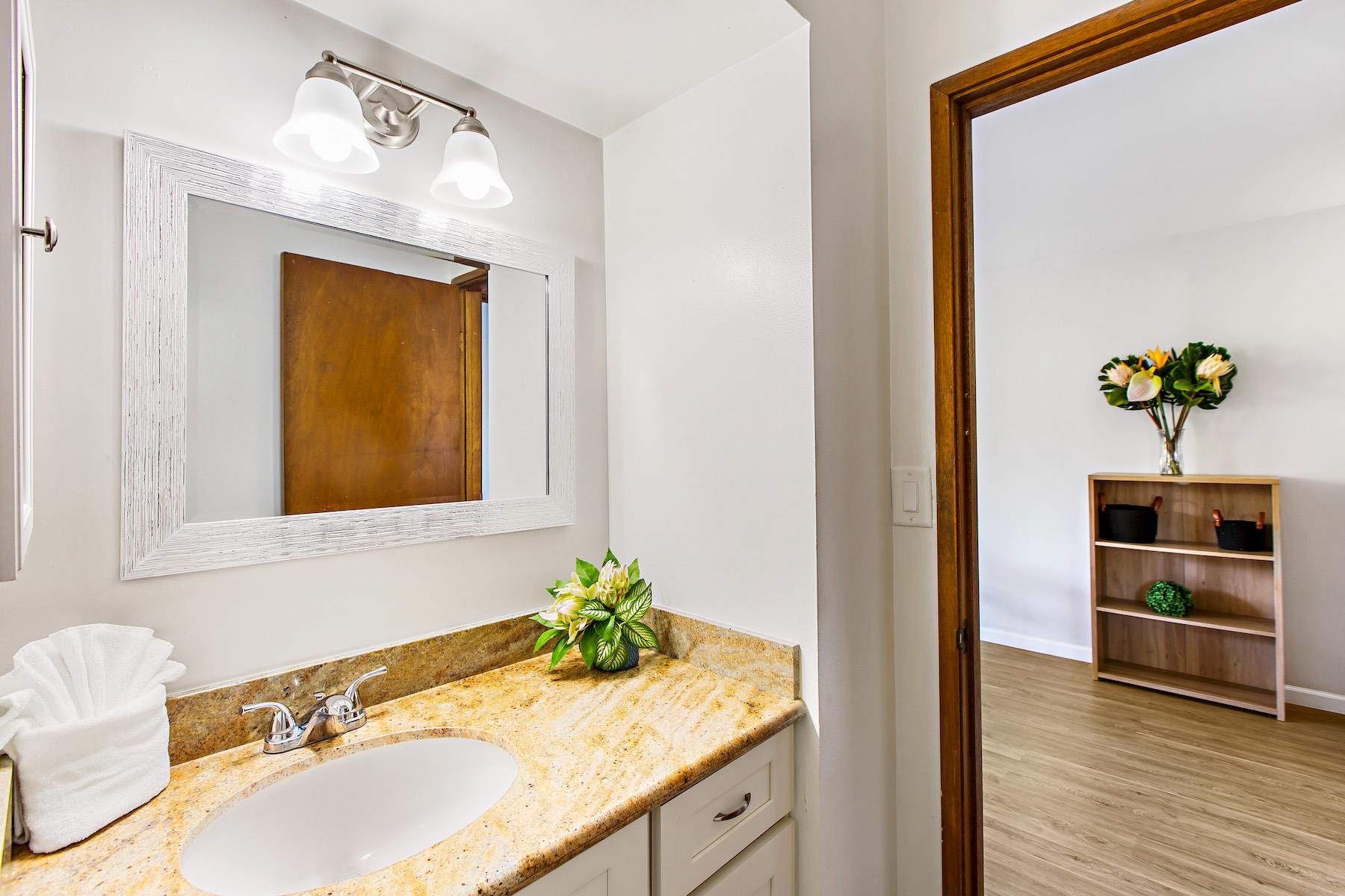 4310 Lower Honoapiilani Road, Unit 218 Lahaina, HI 96761 - Photo 17 of 30 a bathroom with a sink and a mirror