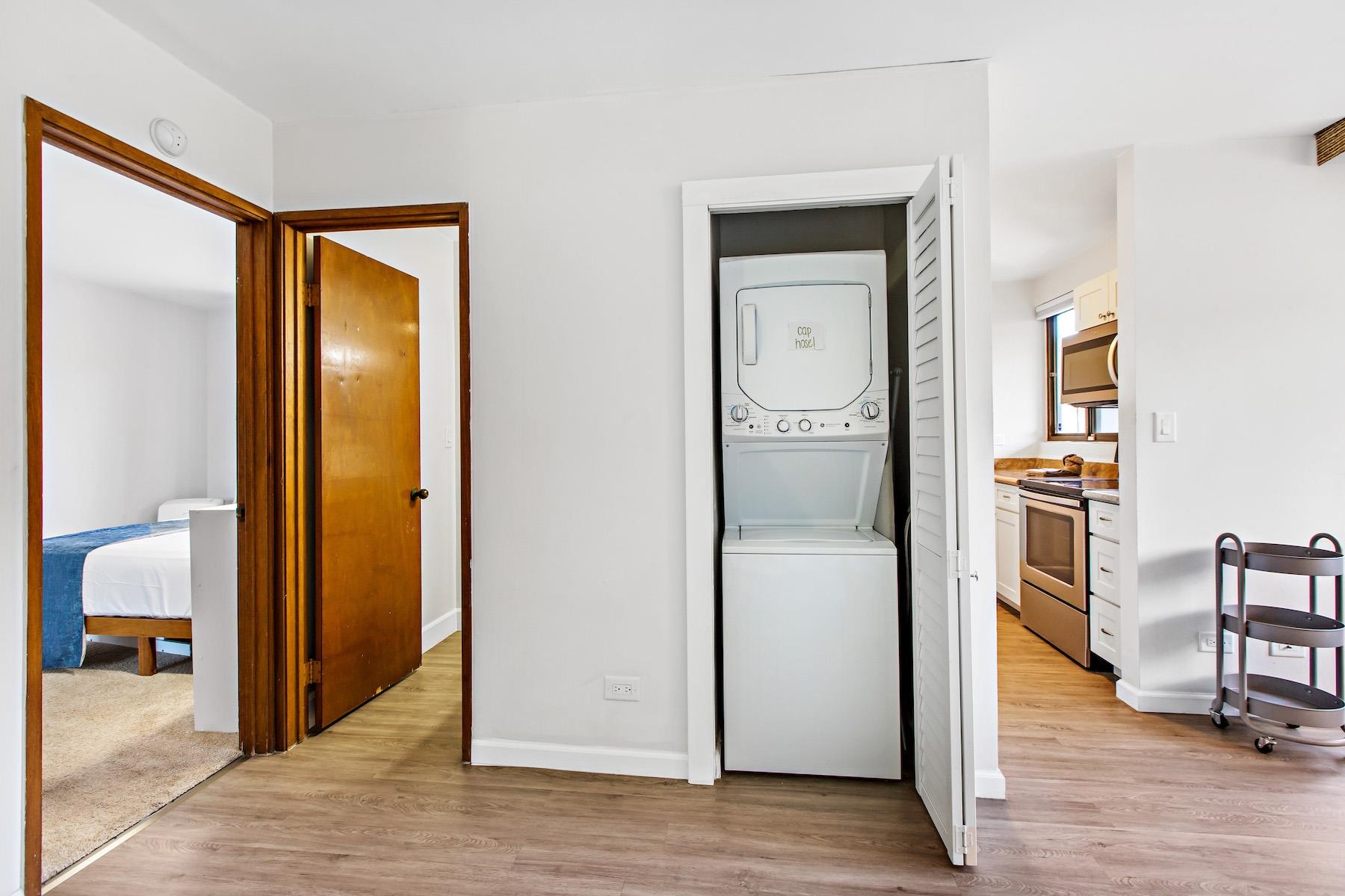 4310 Lower Honoapiilani Road, Unit 218 Lahaina, HI 96761 - Photo 23 of 30 a view of a hallway with wooden floor a bathroom and a bathroom