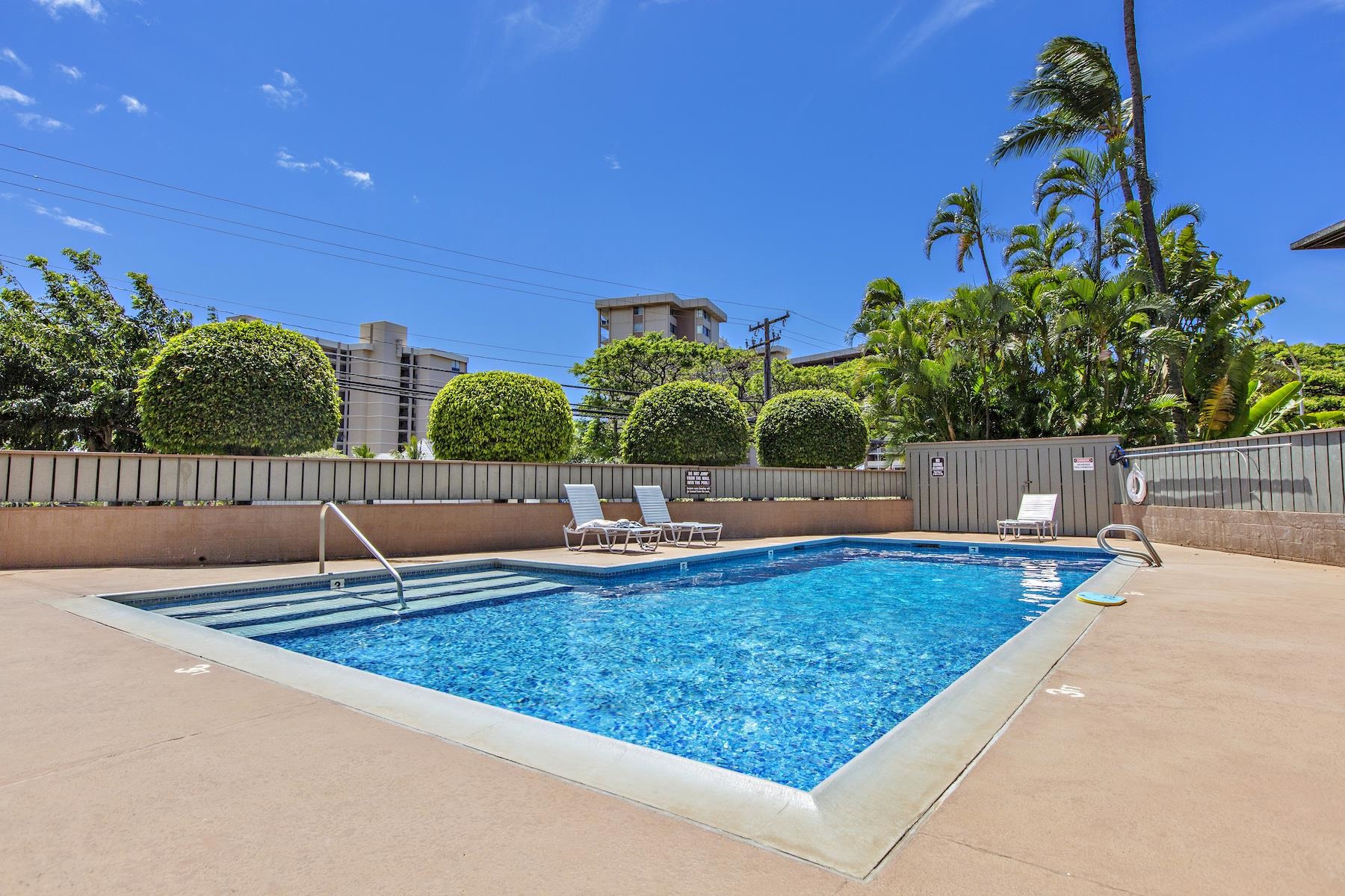 4310 Lower Honoapiilani Road, Unit 218 Lahaina, HI 96761 - Photo 24 of 30 a view of a swimming pool with an outdoor space and seating area