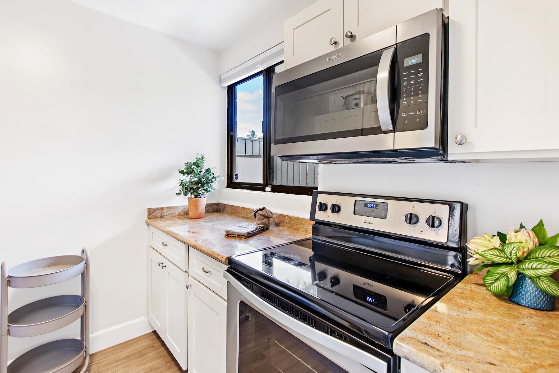4310 Lower Honoapiilani Road, Unit 218 Lahaina, HI 96761 - Photo 6 of 30 a kitchen with a stove and a microwave