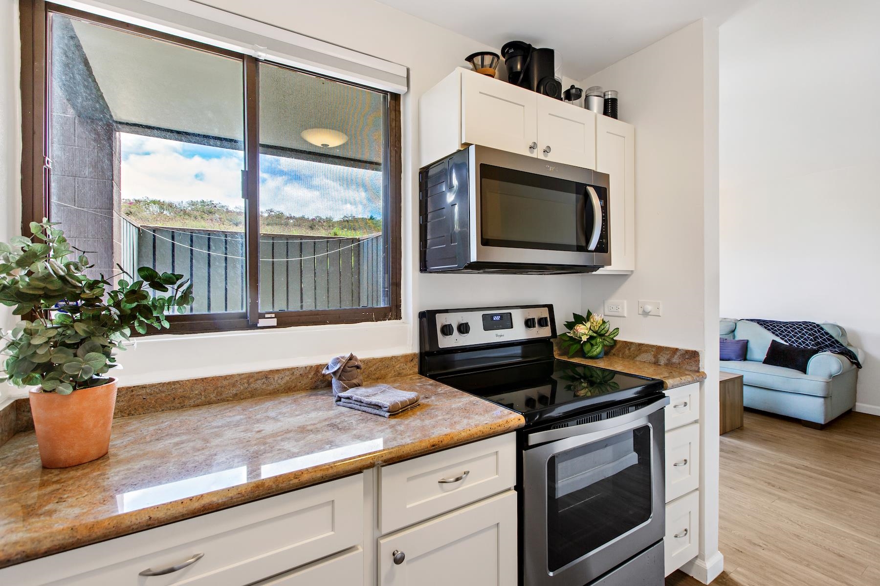4310 Lower Honoapiilani Road, Unit 218 Lahaina, HI 96761 - Photo 7 of 30 a kitchen with a stove and a microwave