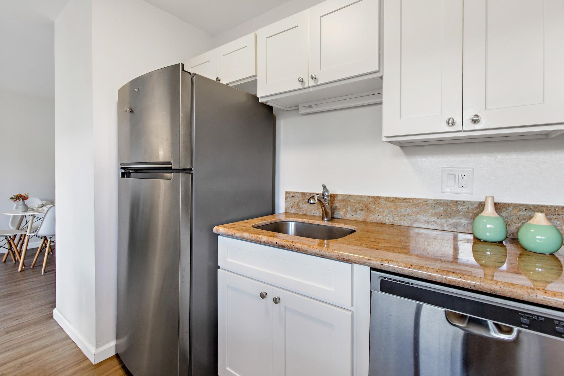 4310 Lower Honoapiilani Road, Unit 218 Lahaina, HI 96761 - Photo 8 of 30 a kitchen with stainless steel appliances granite countertop a refrigerator and a sink