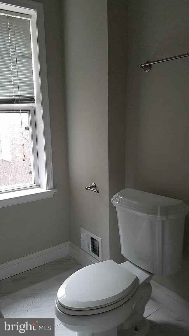 1128 South Hanover Street Baltimore, MD 21230 - Photo 13 of 26 a white toilet sitting next to a window