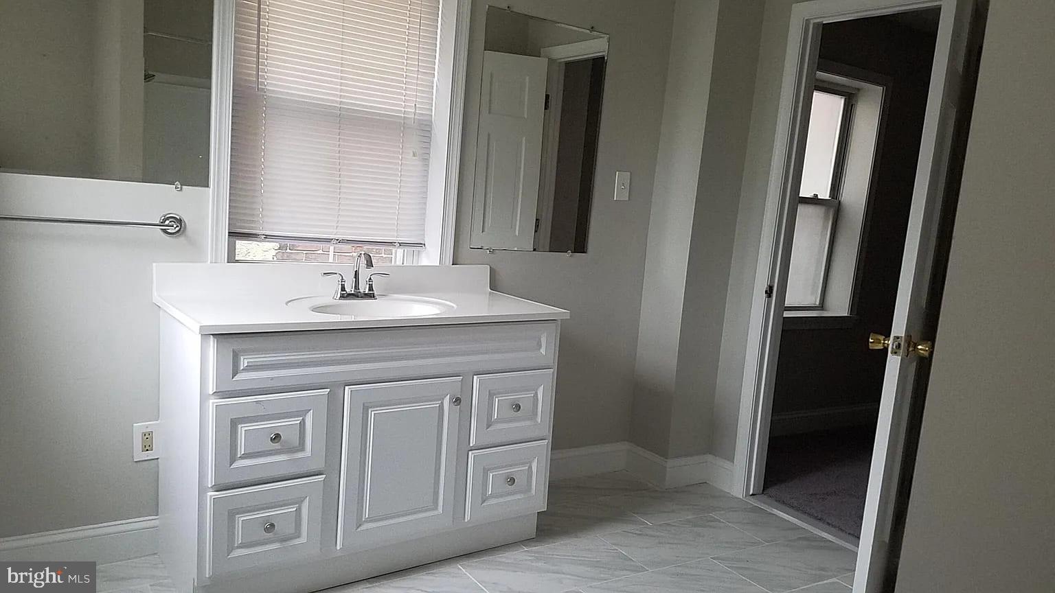 1128 South Hanover Street Baltimore, MD 21230 - Photo 19 of 26 a bathroom with a sink and a mirror