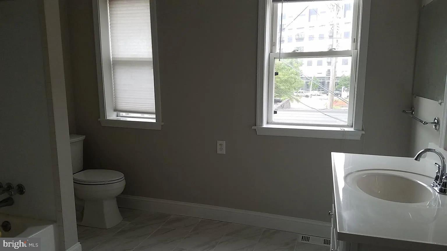 1128 South Hanover Street Baltimore, MD 21230 - Photo 20 of 26 a bathroom with a sink toilet and window