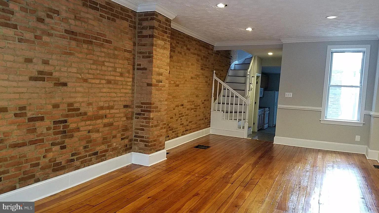 1128 South Hanover Street Baltimore, MD 21230 - Photo 23 of 26 a view of empty room with wooden floor and fan