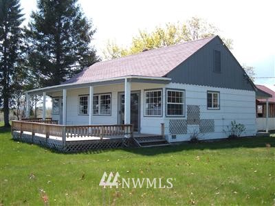a view of house with backyard
