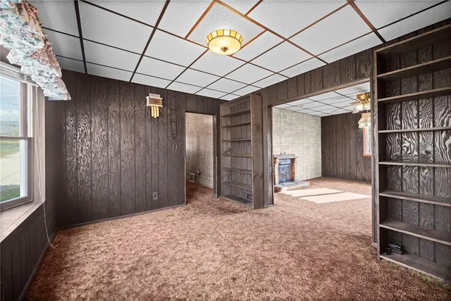 a view of empty room with a fireplace