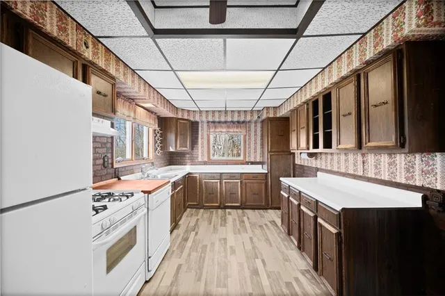a kitchen with a stove sink and cabinets