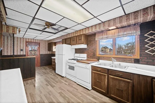 a kitchen with refrigerator and window