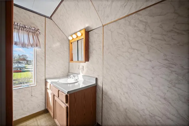 a view of empty room with wooden ceiling