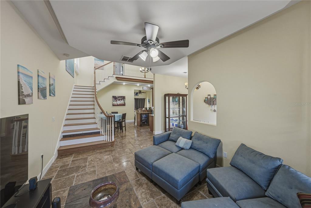 4178 Des Prez Court Hernando Beach, FL 34607 - Photo 11 of 76 a living room with furniture and a chandelier