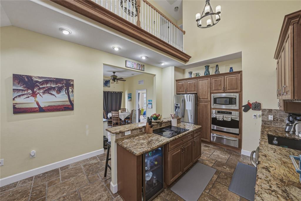 4178 Des Prez Court Hernando Beach, FL 34607 - Photo 15 of 76 a kitchen with stainless steel appliances granite countertop a stove and a refrigerator
