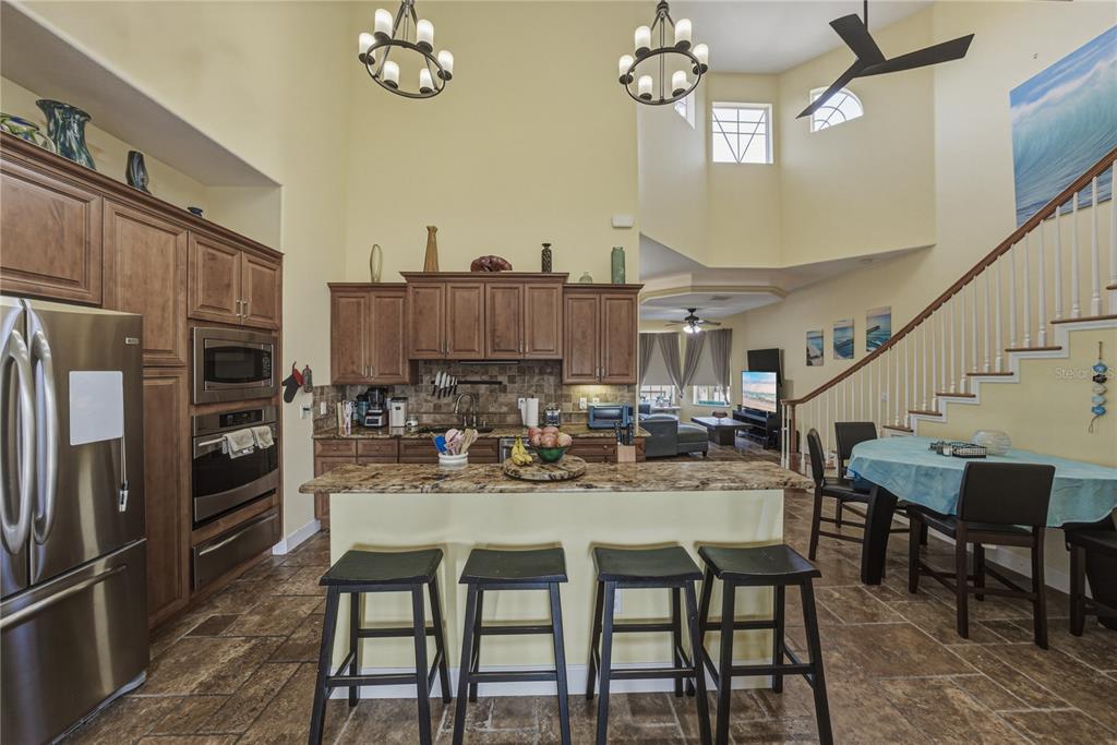 4178 Des Prez Court Hernando Beach, FL 34607 - Photo 19 of 76 a kitchen with a dining table chairs and stainless steel appliances