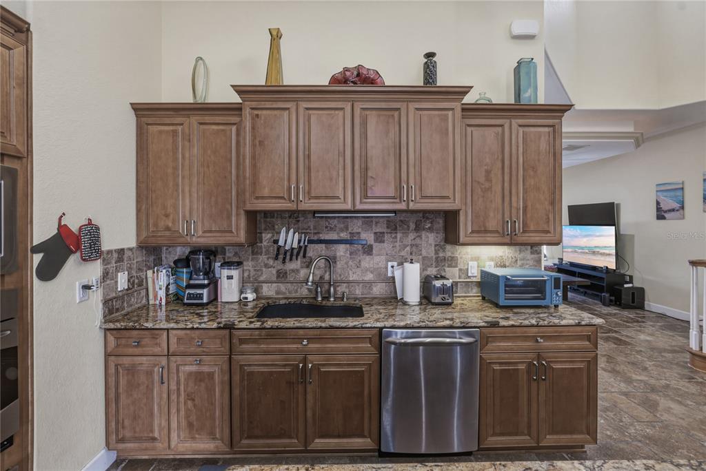 4178 Des Prez Court Hernando Beach, FL 34607 - Photo 20 of 76 a kitchen with stainless steel appliances granite countertop a sink stove and cabinets
