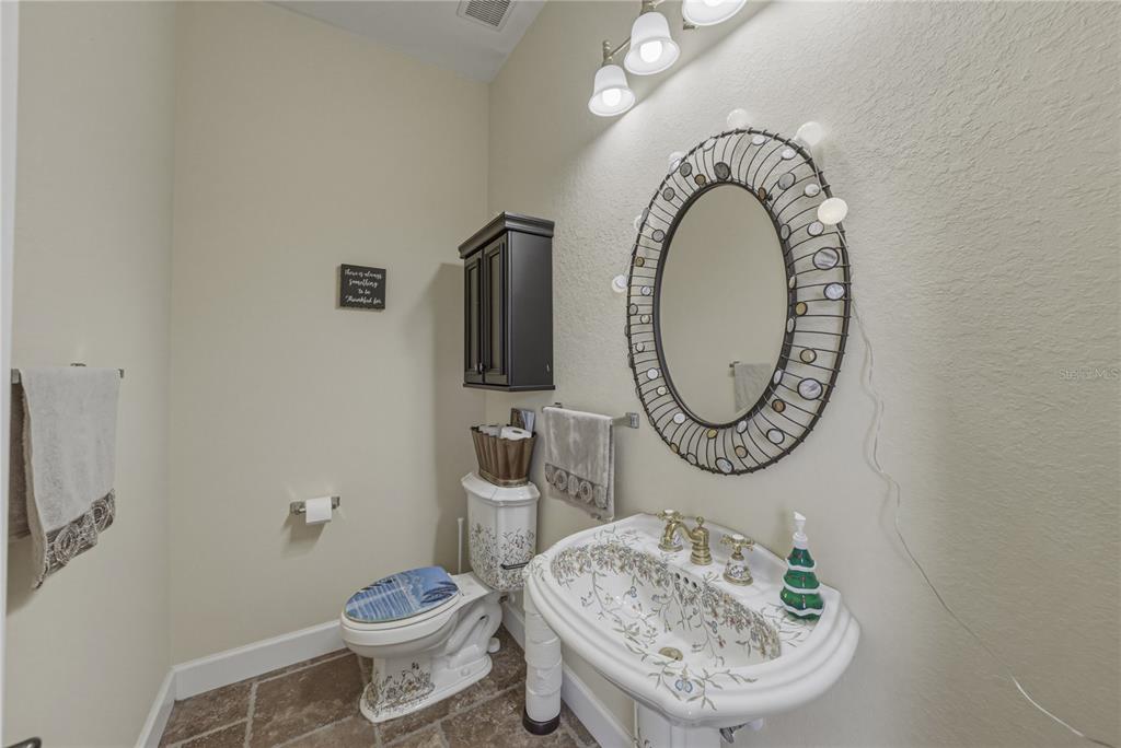 4178 Des Prez Court Hernando Beach, FL 34607 - Photo 25 of 76 a bathroom with a toilet a sink and a mirror