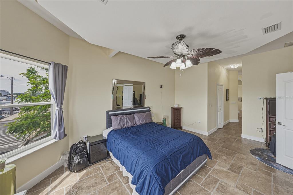 4178 Des Prez Court Hernando Beach, FL 34607 - Photo 30 of 76 a bedroom with a bed dresser and a large window