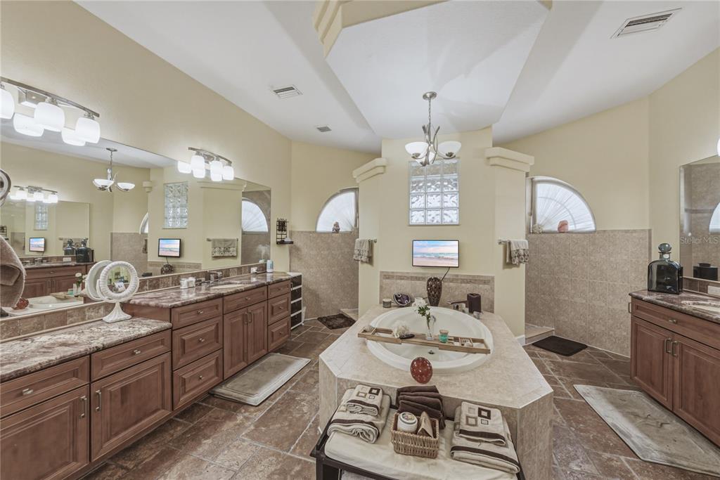 4178 Des Prez Court Hernando Beach, FL 34607 - Photo 32 of 76 a large kitchen with a counter space a sink appliances and dining table