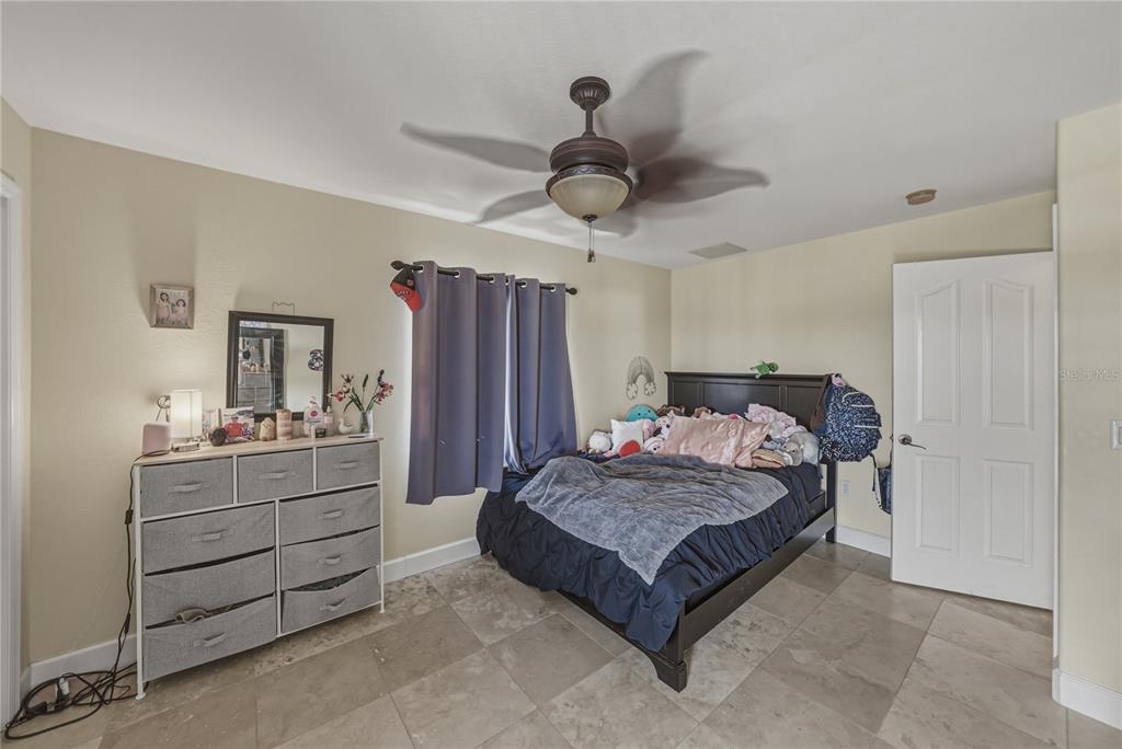 4178 Des Prez Court Hernando Beach, FL 34607 - Photo 40 of 76 a bedroom with a bed and a chandelier