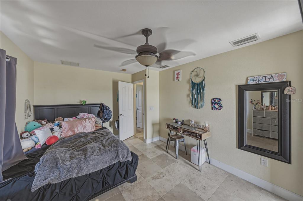 4178 Des Prez Court Hernando Beach, FL 34607 - Photo 41 of 76 a bedroom with a bed and a chandelier