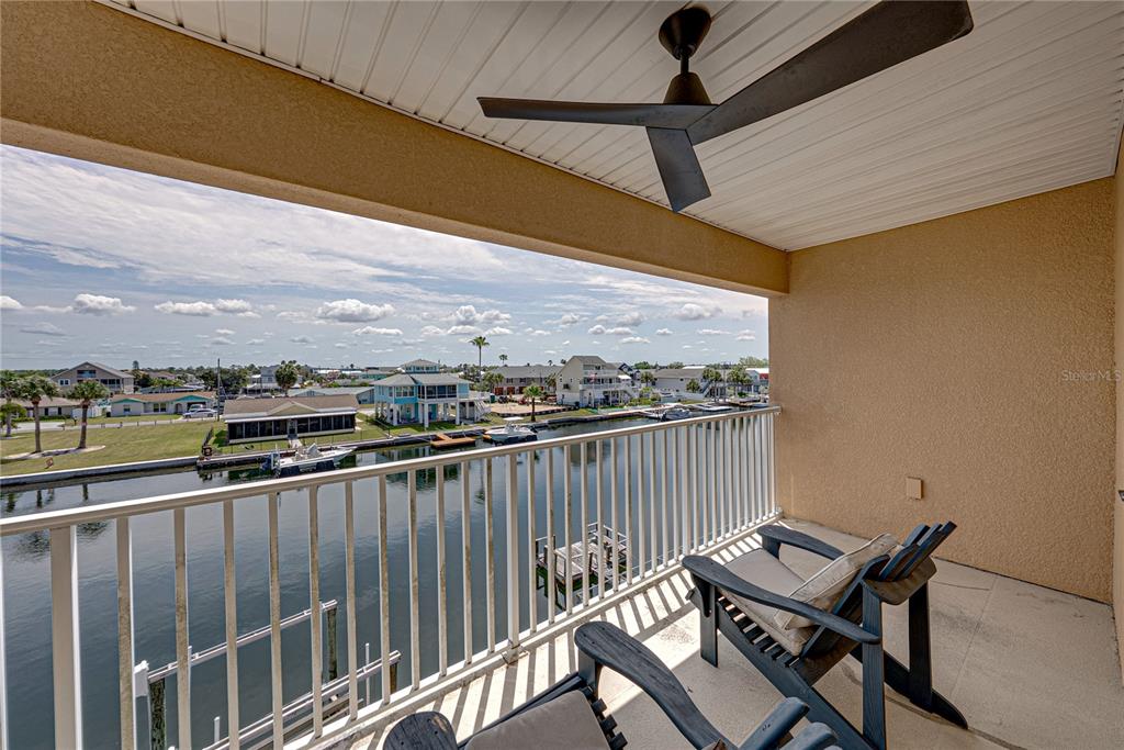 4178 Des Prez Court Hernando Beach, FL 34607 - Photo 43 of 76 a view of a balcony with wooden floor and iron stairs