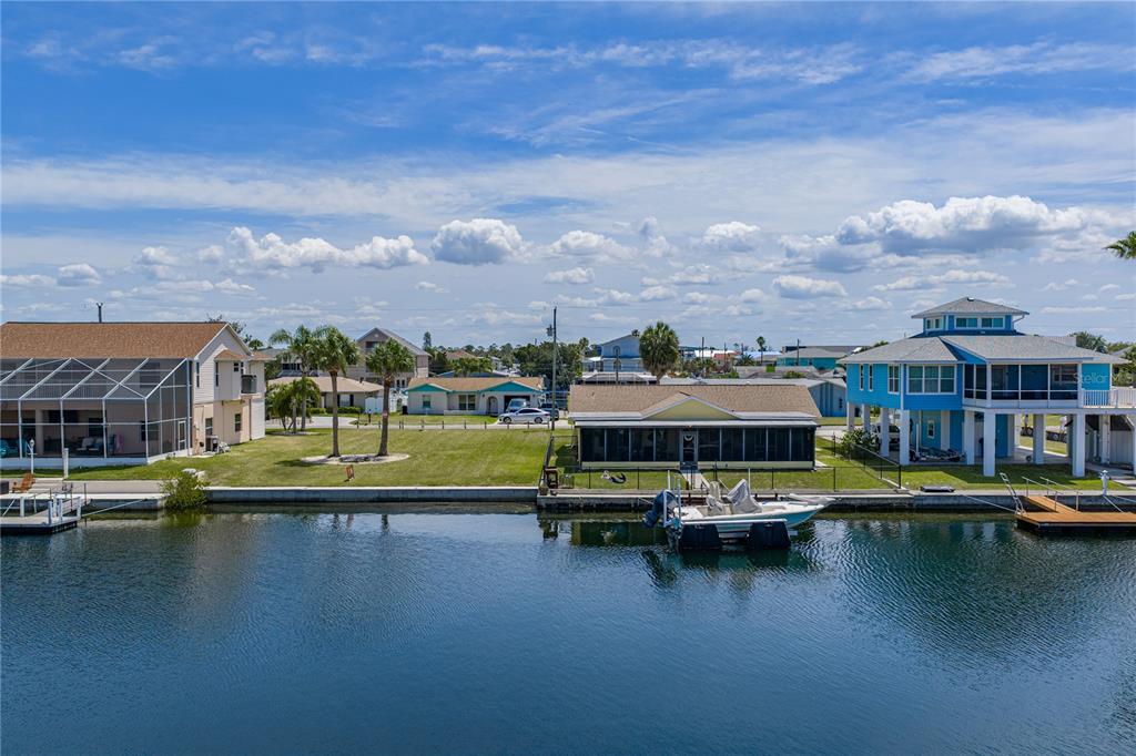 4178 Des Prez Court Hernando Beach, FL 34607 - Photo 67 of 76 a view of an ocean with boats and buildings in the background