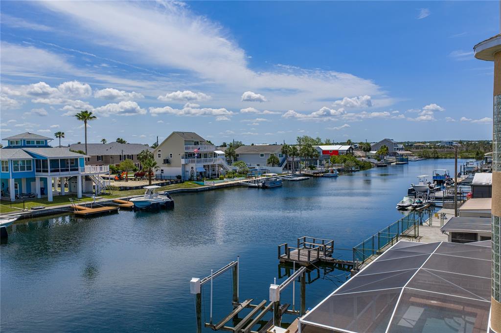 4178 Des Prez Court Hernando Beach, FL 34607 - Photo 68 of 76 a view of a lake with boats and palm trees