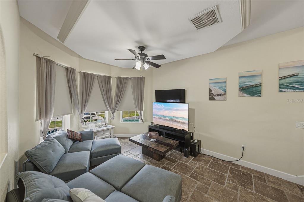 4178 Des Prez Court Hernando Beach, FL 34607 - Photo 9 of 76 a living room with furniture a flat screen tv and a window