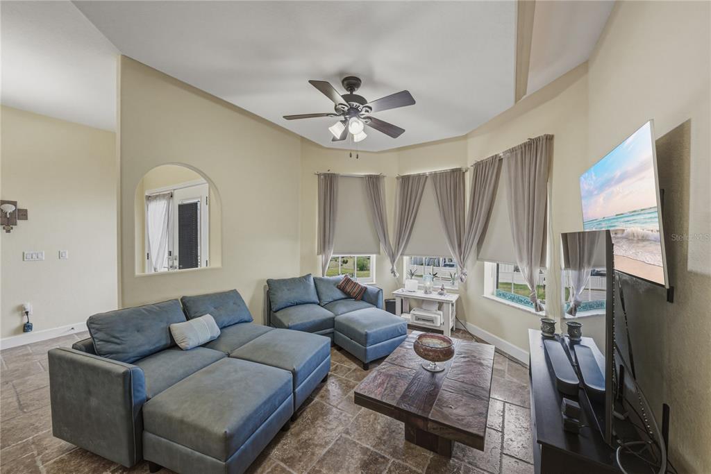 4178 Des Prez Court Hernando Beach, FL 34607 - Photo 10 of 76 a living room with furniture a flat screen tv and a large window