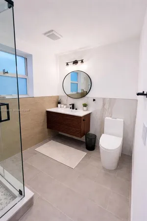 a living room with furniture and a mirror