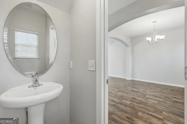 a bathroom with a sink a mirror and vanity