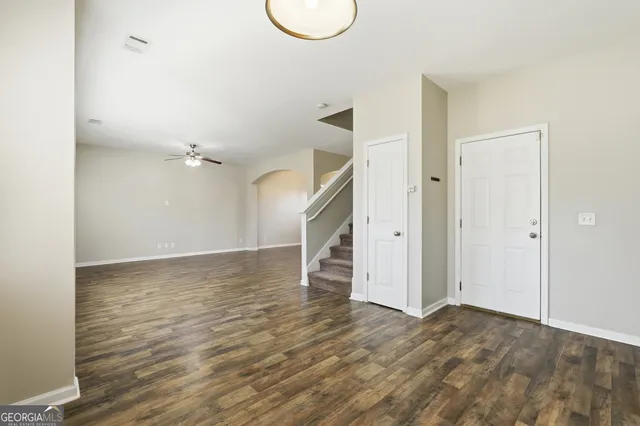 a view of empty room with wooden floor and window
