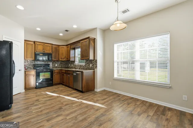 a kitchen with a refrigerator and a sink