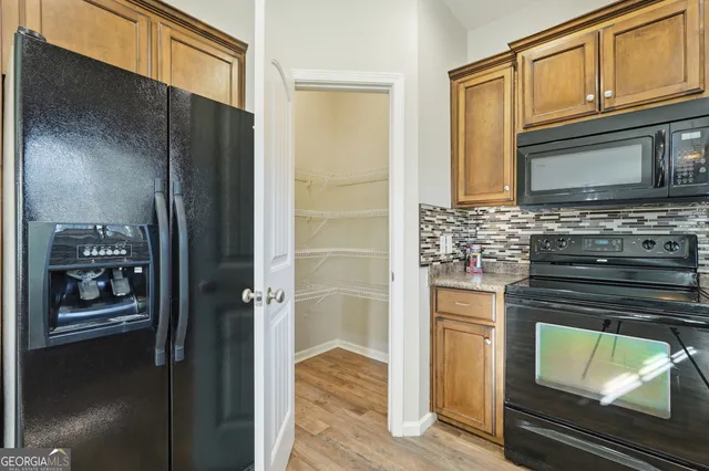 a kitchen with granite countertop a stove and a microwave