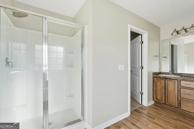 a bathroom with a shower and a sink