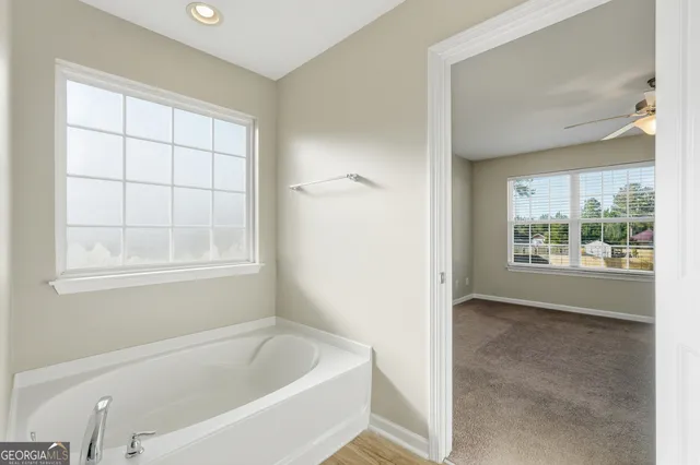 a bathroom with a bathtub and window