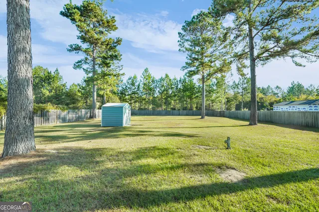 a view of a swimming pool and a yard