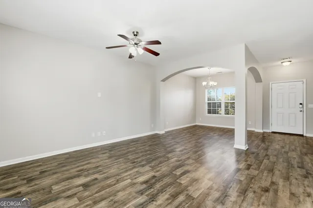 a view of a big room with wooden floor closet and windows