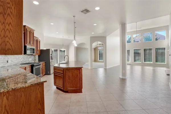 a open kitchen with stainless steel appliances granite countertop a stove and cabinets